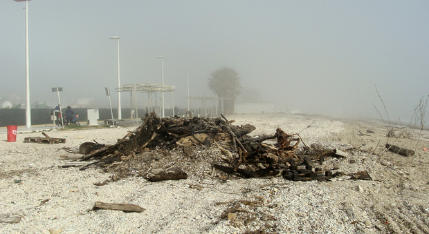 I detriti in spiaggia bruciati durante la notte