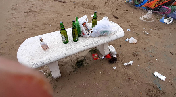 Bottiglie di alcolici e rifiuti abbandonati in spiaggia